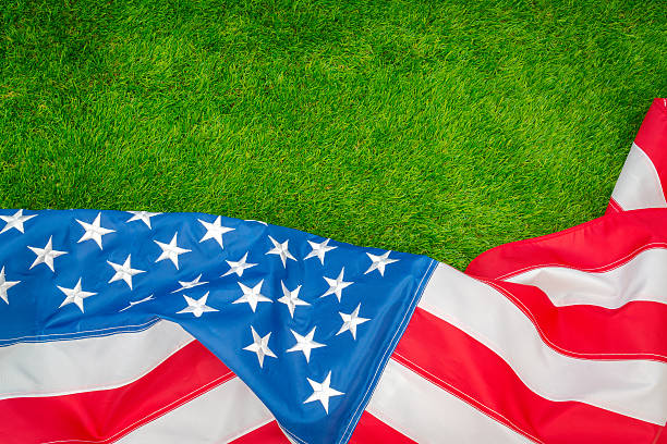 istock American flag on green grass 624906496