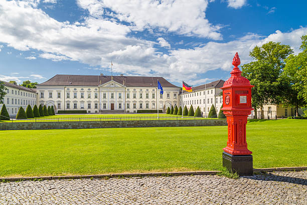 Classic view of famous Schloss Bellevue, official residence of the President of the Federal Republic of Germany, with fire post on a sunny day with blue sky and clouds in summer in Berlin, Germany