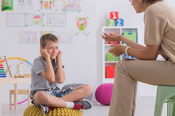 istock Misbehaving boy during session with a psychotherapist 624909076