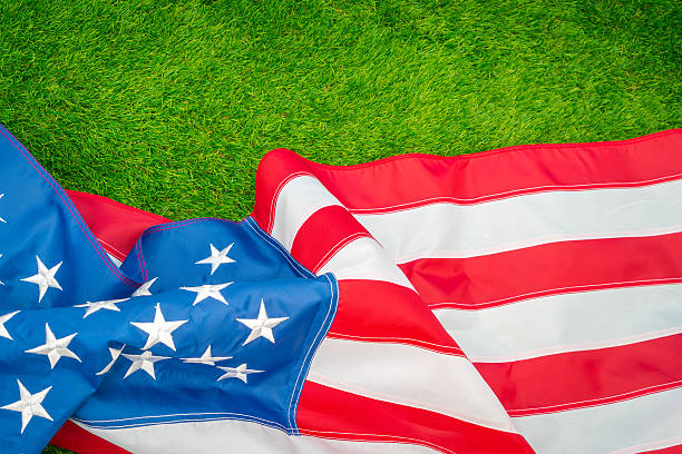 istock American flag on green grass 624909498