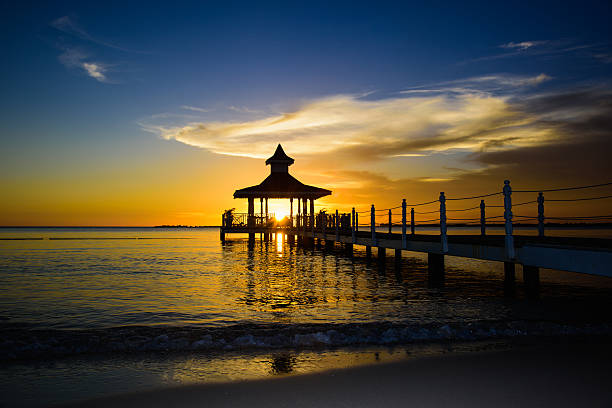 gazebo bridge in the sea at sunset evening sky