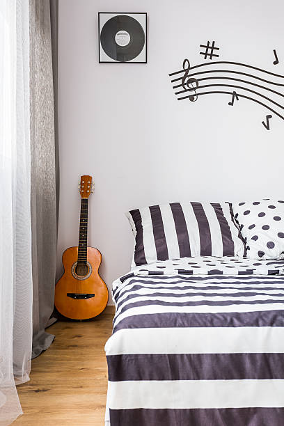 istock Bedroom with a guitar next to the bed 624912048
