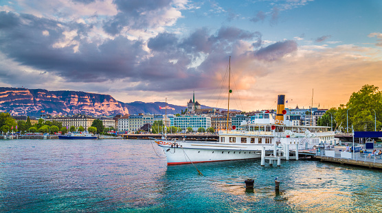 Historic city of Geneva with paddle steamer at sunset, Switzerland