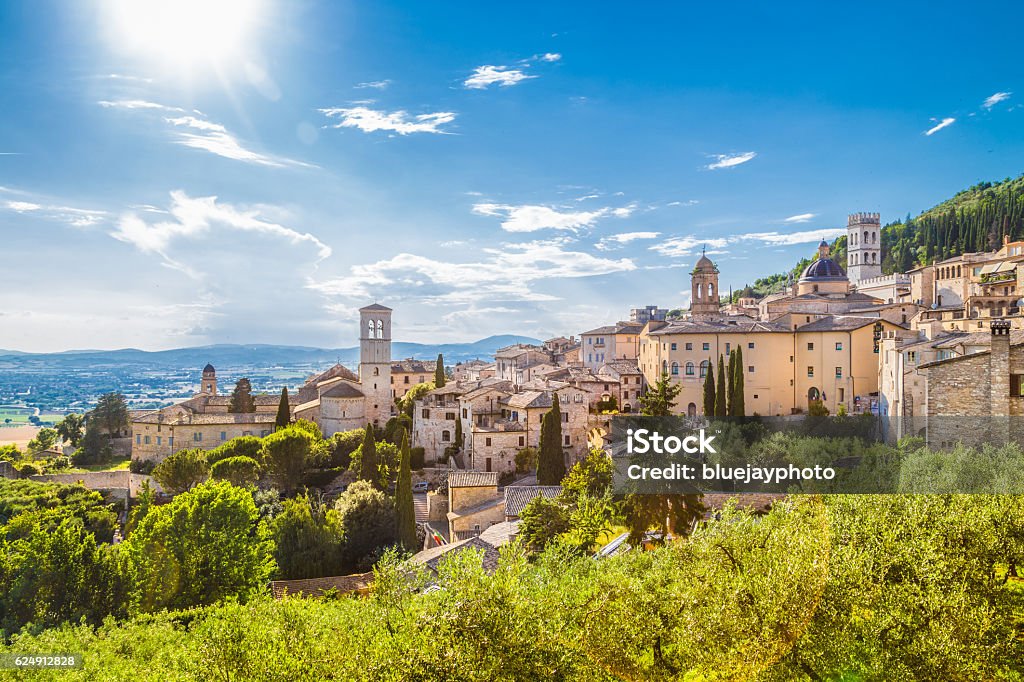 Historic town of Assisi, Umbria, Italy Panoramic view of the historic town of Assisi on a beautiful sunny day with blue sky and clouds in summer, Umbria, Italy. Italy Stock Photo