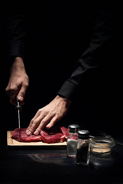 istock Close up of mans hands chopping meat in restaurant 624912830