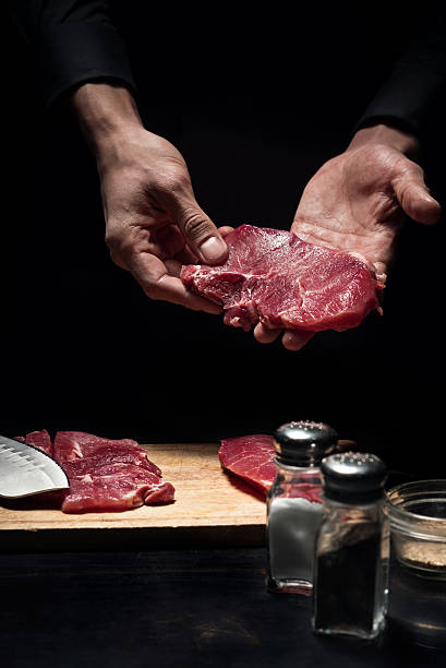 istock Close up of chefs hands holding meat 624923188