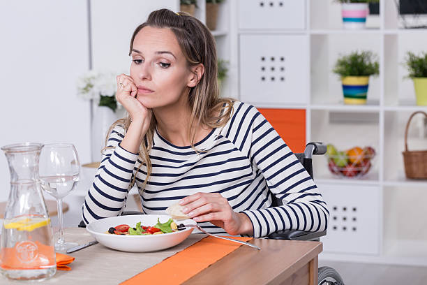 istock Women on wheelchair at the dinner table 624924256