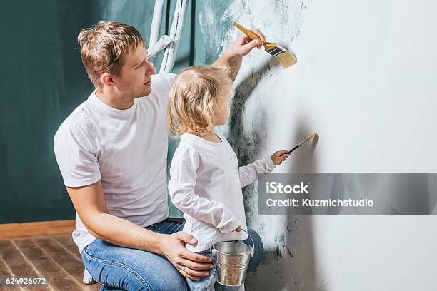 Familia Hija Feliz Con Papá Haciendo Reparación Del Hogar Paredes De Pintura Foto de stock y más banco de imágenes de Pintar