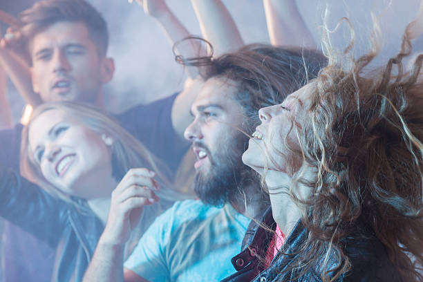 istock Crowd of people dancing at concert 624926310