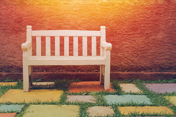 istock White bench in the park with sunset. 624928474