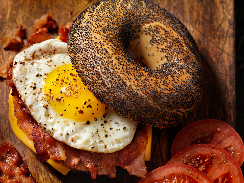 Poppyseed Bagel Sandwich with A Fried Egg, Bacon, Cheese and Tomatoes - Photographed on Hasselblad H3D2-39mb Camera