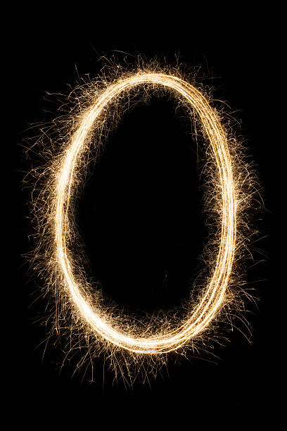 istock Letter or number null O from sparklers alphabet on black 624929920