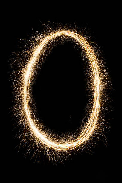 Letter or number null O from sparklers alphabet on black English letter O or null zero number made from burning sparkles on black background. Shiny festive party firework font, latin alphabet text queen sign. flaming o symbol stock pictures, royalty-free photos & images