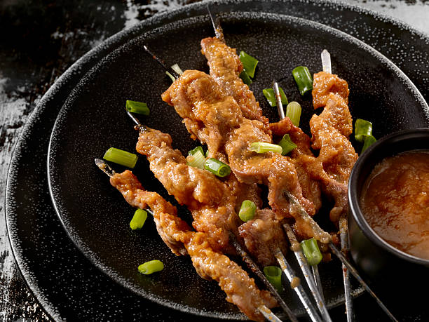 Pork Satay with Peanut Sauce Pork (also looks like Chicken) Skewers with Peanut Sauce and Green onion-Photographed on Hasselblad H3D2-39mb Camera skewer photos stock pictures, royalty-free photos & images