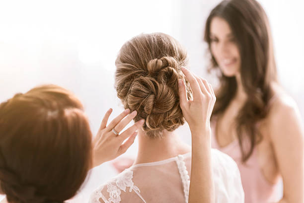 istock Pleasant bridesmaids helping the bride with her hairstyle 624944792