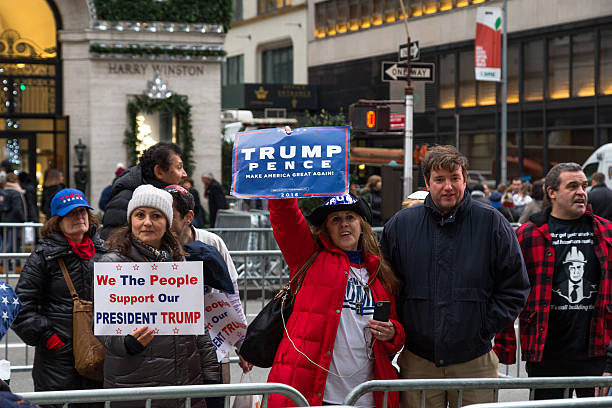 Trump supporters in New York City New York, United States of America - November 20, 2016: A group of Donald Trump supporters on 5th avenue in front of the Trump Tower in Manhattan 2016 stock pictures, royalty-free photos & images