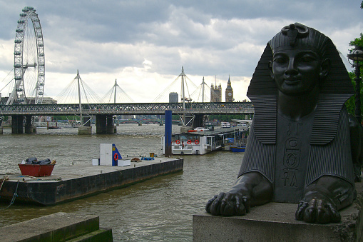 London, England - June 12 2005: Sphinx of the Cleopatra's needle in London with behind, the Golden Jubilee Bridge,the Westminster Bridge, London eye and Big Ben.