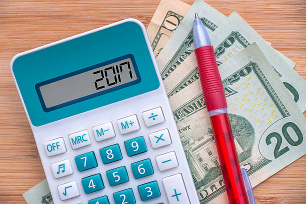 istock 2017 written on a calculator and dollars banknotes 624947950