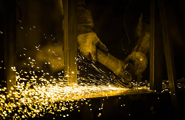 istock industrial worker grinding steel in workshop 624949796