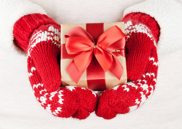istock Female hands holding christmas gift 624950186