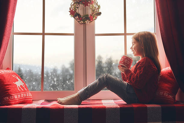 istock girl sitting by window 624950876