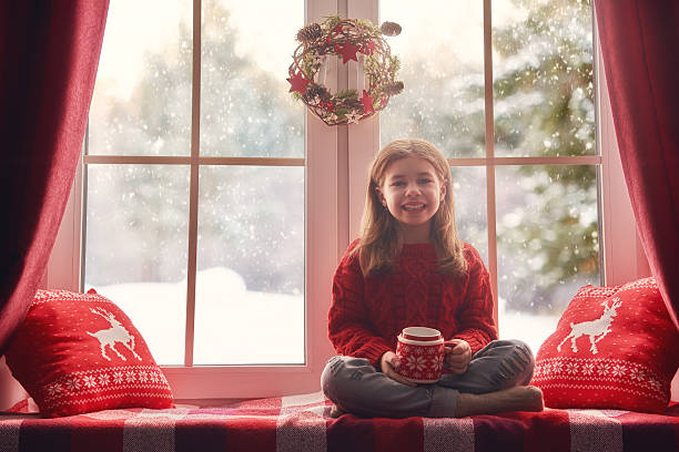 istock girl sitting by window 624950976