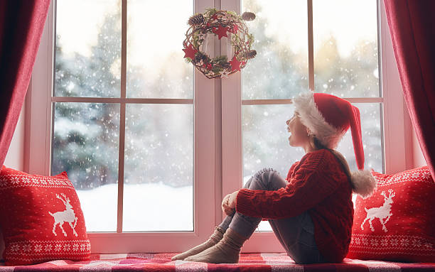 istock girl sitting by the window 624951082