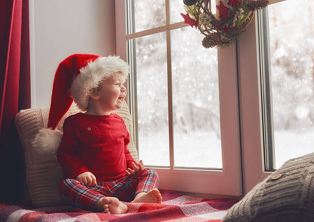 istock baby girl sitting by the window 624951412