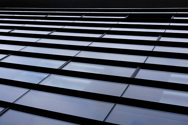 istock Modern glass architecture. Tilt photo of long purple rectangular windows. 624956226
