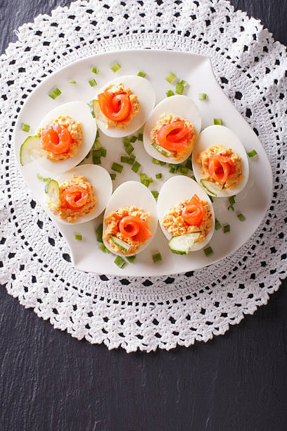istock Eggs stuffed with salmon, cheese and cucumber. vertical top view 624956486