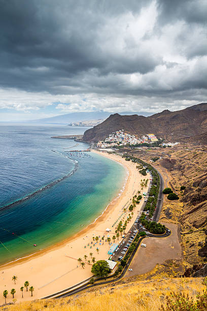 istock Teresitas beach with sunbeds and mountains on the background 624958994