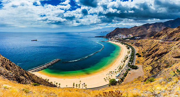 istock Teresitas beach with sunbeds and mountains on the background 624959536