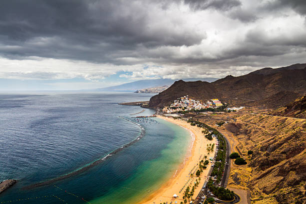 istock Teresitas beach with sunbeds and mountains on the background 624965186