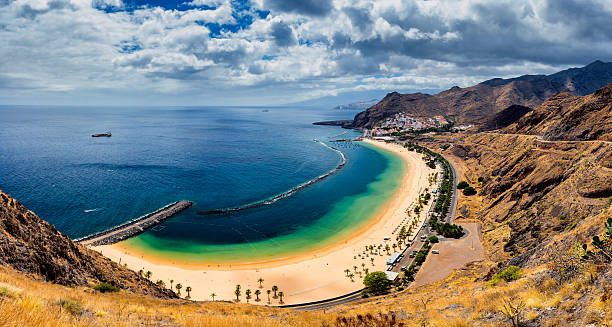 istock Teresitas beach with sunbeds and mountains on the background 624965932