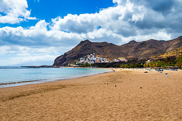 istock Teresitas beach with sunbeds and mountains on the background 624966014