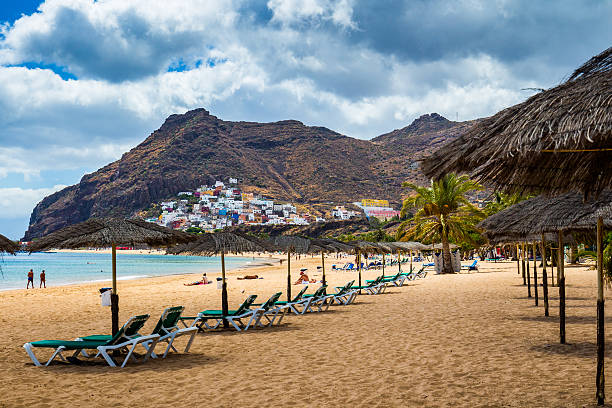 istock Teresitas beach with sunbeds and mountains on the background 624966090