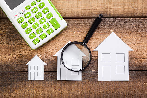 istock paper house with Magnifying Glass 624966384