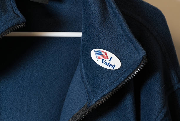 istock I Voted sticker on blue jacket hung on hanger 624967040