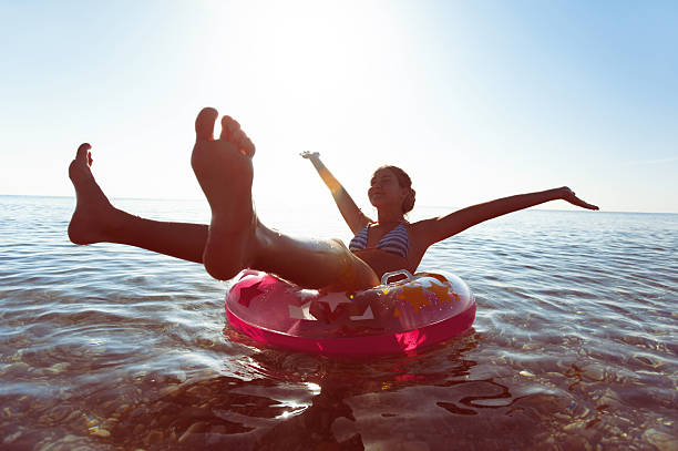 istock Unforgetable summertime enjoyment! Swimming on iflatable ring. 624967368