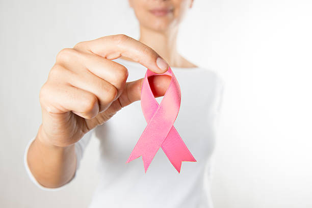 Woman Holding Pink Ribbon stock photo