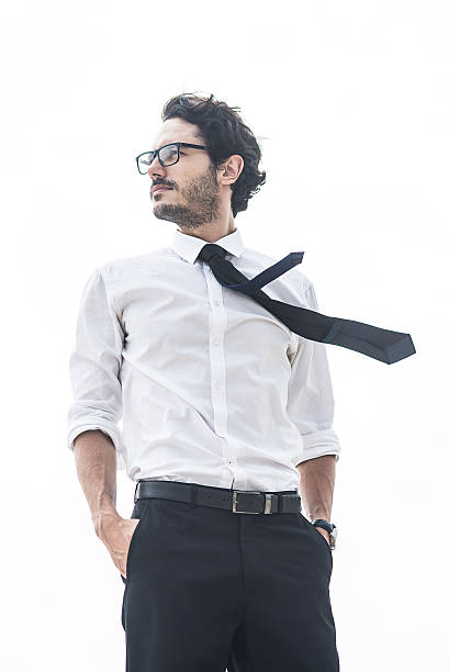 handsome man standing with his hands in pockets - necktie isolated clothing white imagens e fotografias de stock