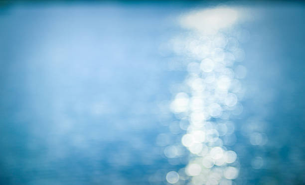 istock sun reflecting on the water in the blue tone 624979002