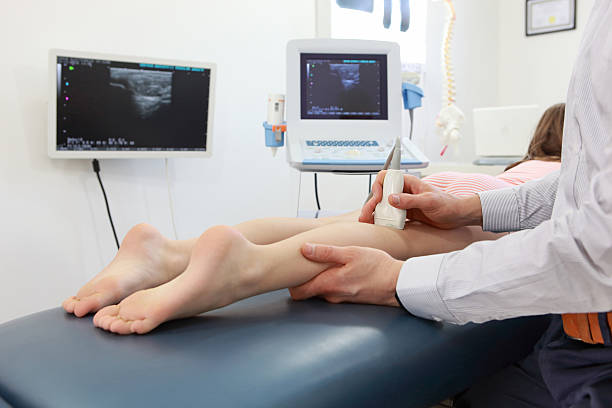 Ultrasound of kid's knee-joint - diagnosis stock photo