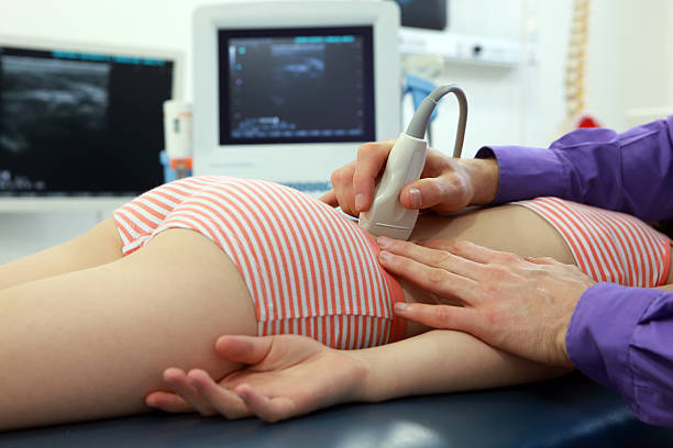 istock girl's lower back diagnosis with ultrasound 624986826