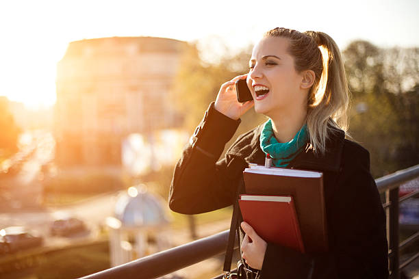 istock Beautiful student girl talking on the phone at sunset. 624987956
