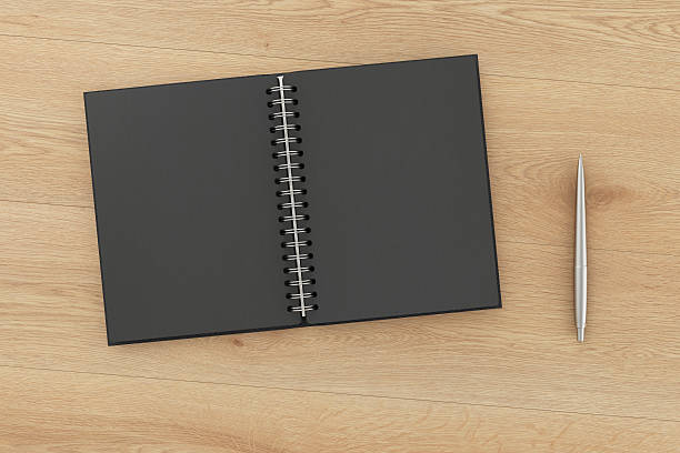 istock Blank facing pages of notebook on a spring and pen 624988208