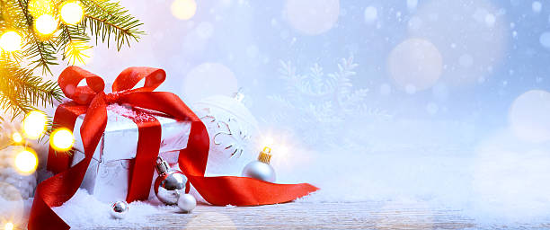 istock Christmas holidays background with gift box; snow fir tree, holi 624988484