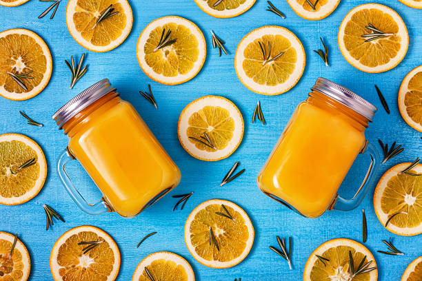 istock Orange juice on a blue background, top view. 624989468