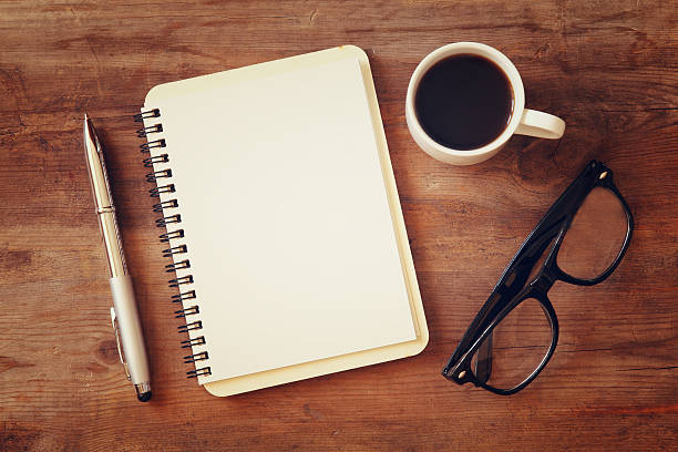 istock open notebook with blank pages next to cup of coffee 624989866