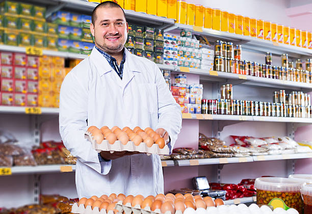 istock Seller posing with dozens of eggs 625006436